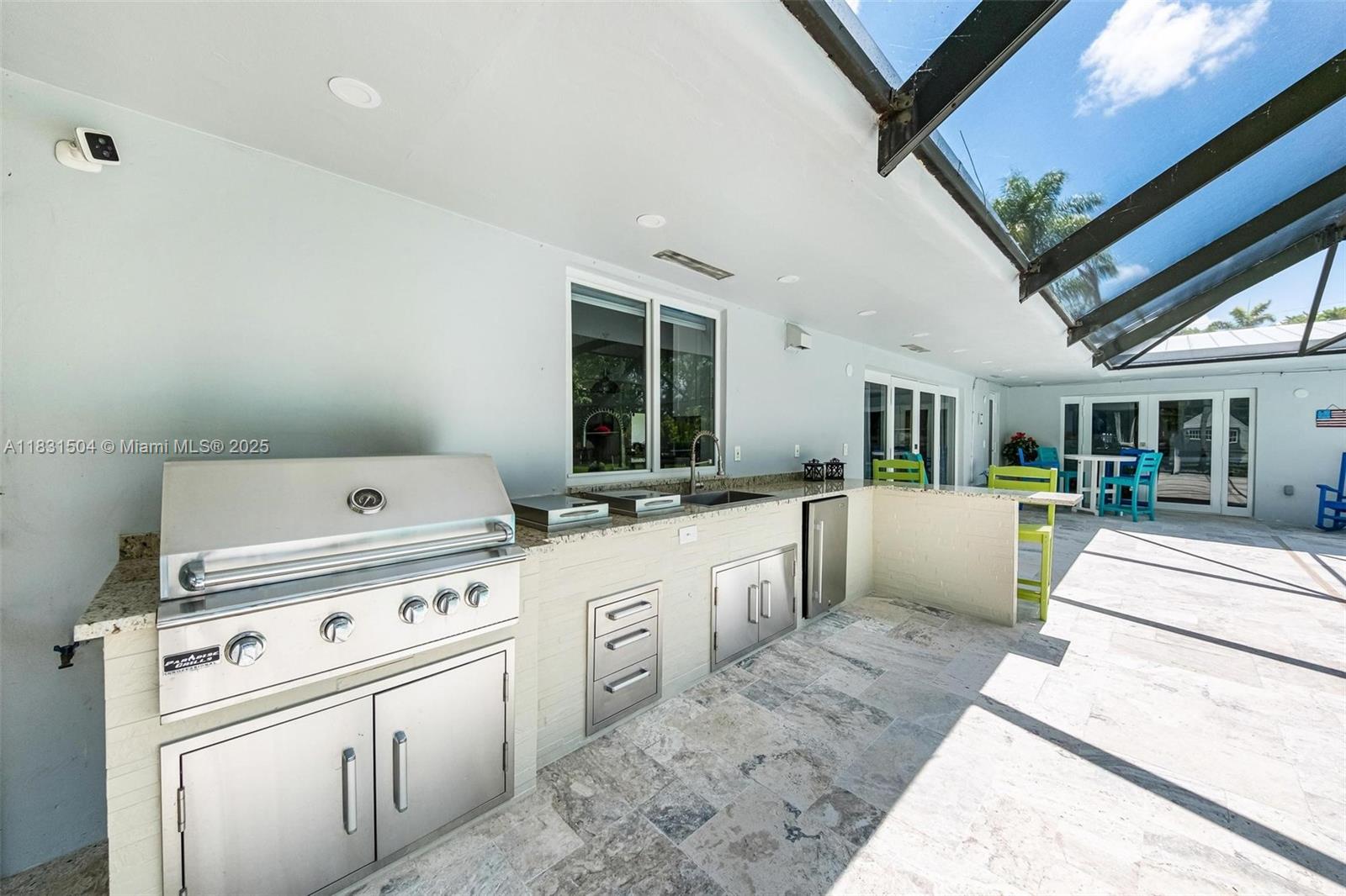 9720 Southwest 140th Street Miami, FL 33176 - Photo 22 of 24 a open kitchen with stove a sink dishwasher and white cabinets with wooden floor