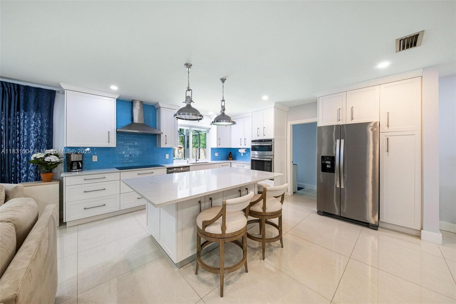 9720 Southwest 140th Street Miami, FL 33176 - Photo 5 of 24 a kitchen with stainless steel appliances kitchen island granite countertop a refrigerator and a stove top oven