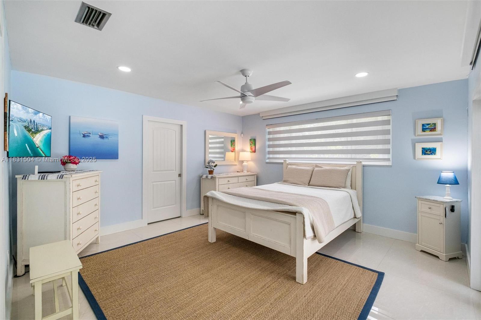 9720 Southwest 140th Street Miami, FL 33176 - Photo 10 of 24 a bedroom with a bed and a flat tv screen on dresser