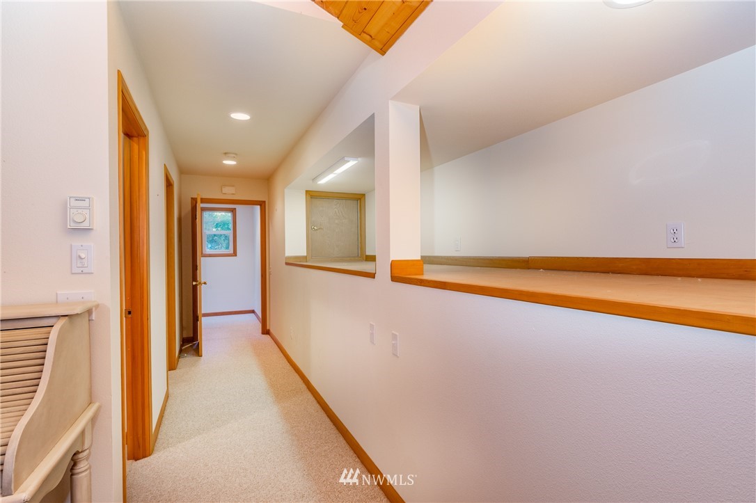 5101 East Harbor Road Freeland, WA 98249 - Photo 8 of 24 a view of a big room with wooden floor and windows
