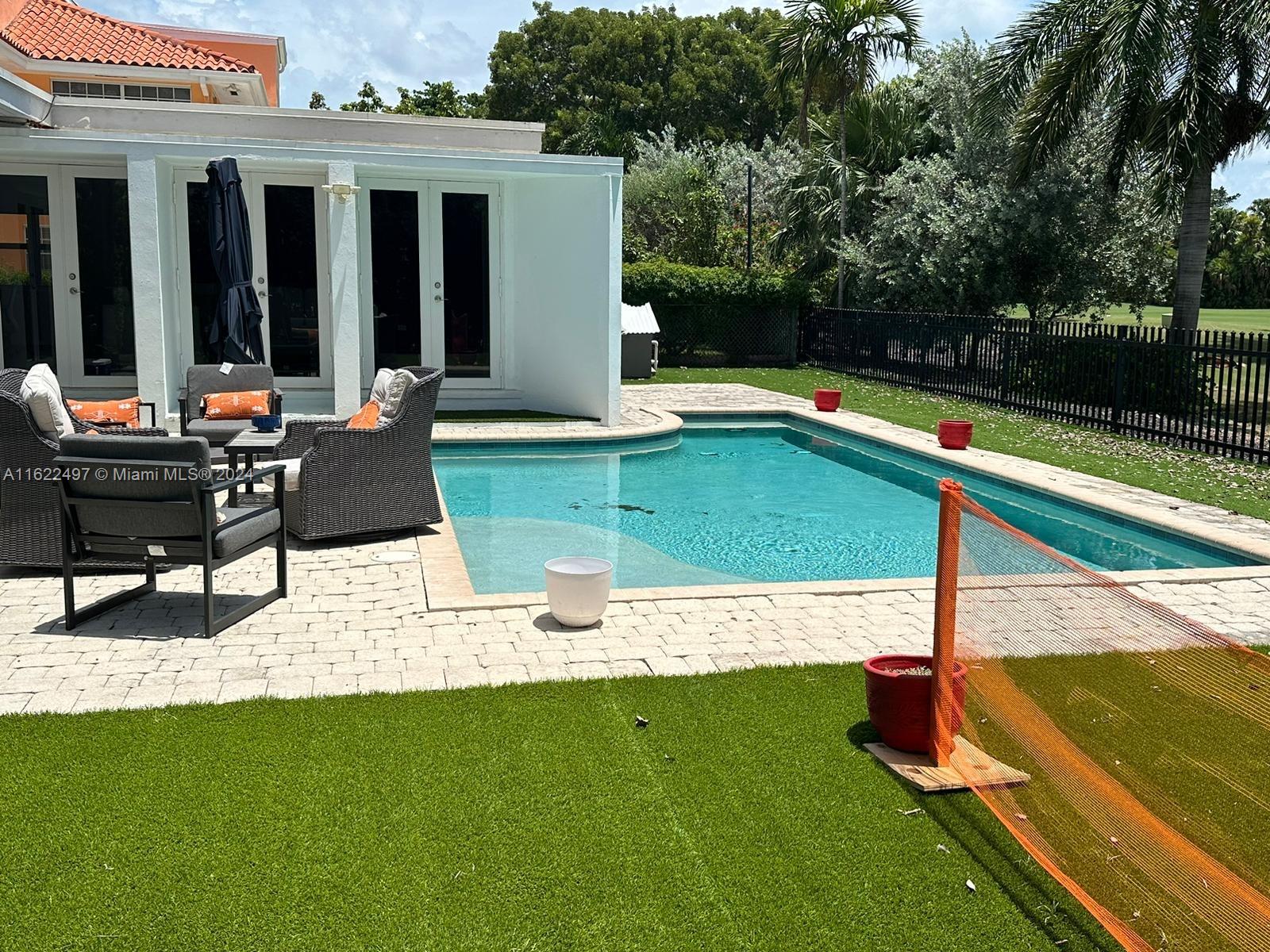 a view of a patio with chairs and plants