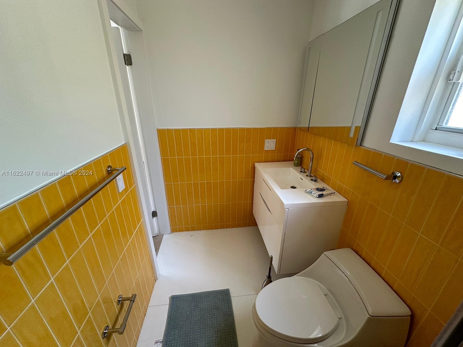 5301 Alton Road Miami Beach, FL 33140 - Photo 28 of 46 a white toilet sitting next to a sink