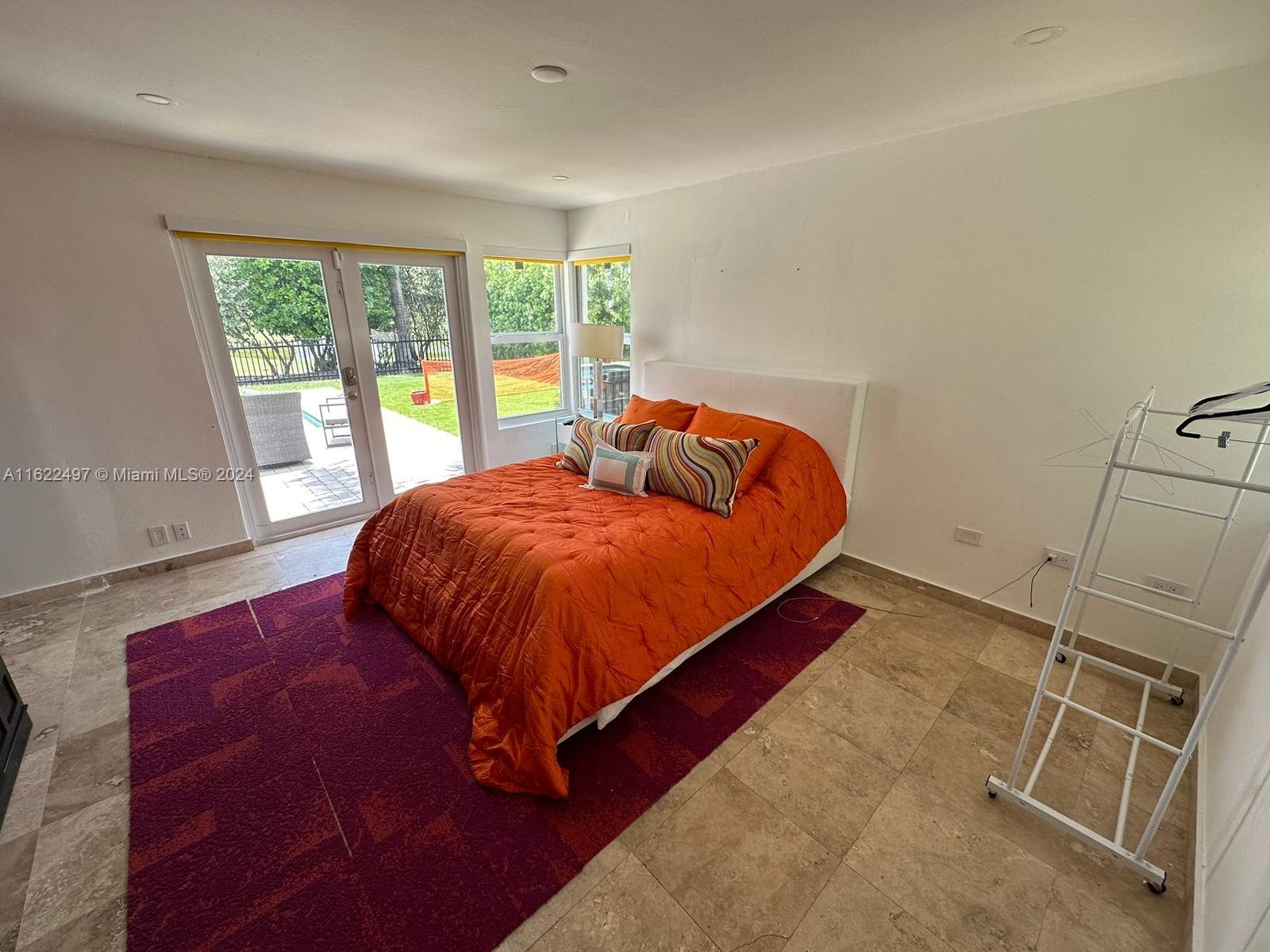 5301 Alton Road Miami Beach, FL 33140 - Photo 30 of 46 a bed sitting in a bedroom next to a window