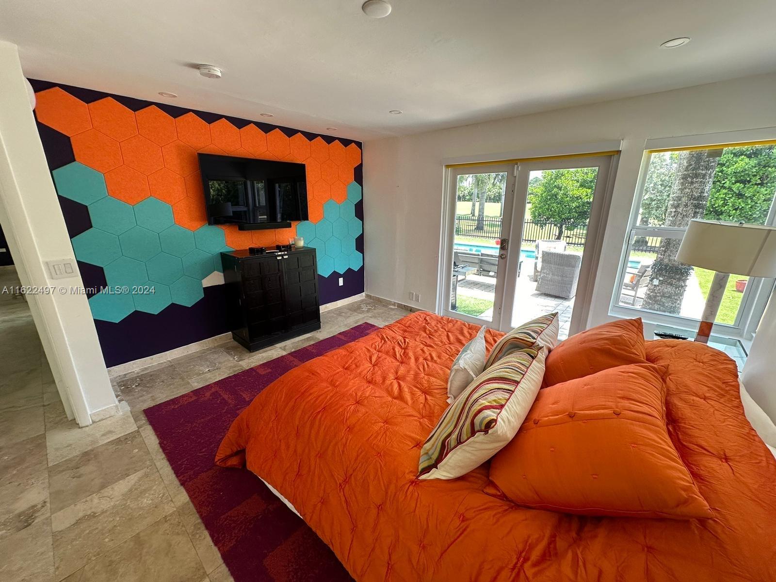 5301 Alton Road Miami Beach, FL 33140 - Photo 32 of 46 a bed sitting in a bedroom next to a window