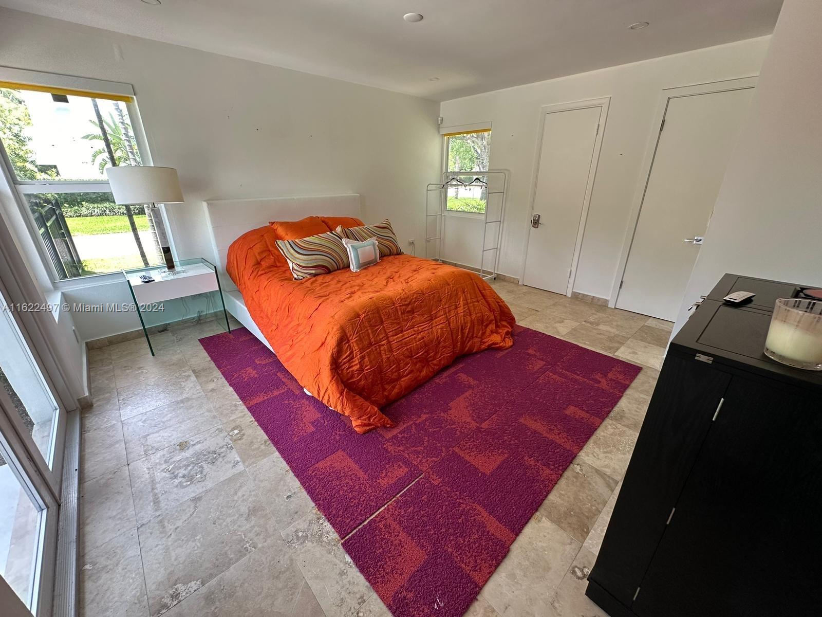 5301 Alton Road Miami Beach, FL 33140 - Photo 33 of 46 a bedroom with a bed and a window