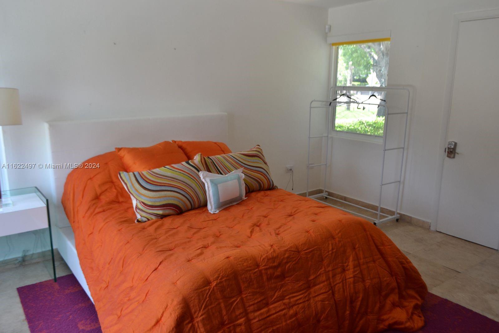 5301 Alton Road Miami Beach, FL 33140 - Photo 34 of 46 a bedroom with a bed and a window