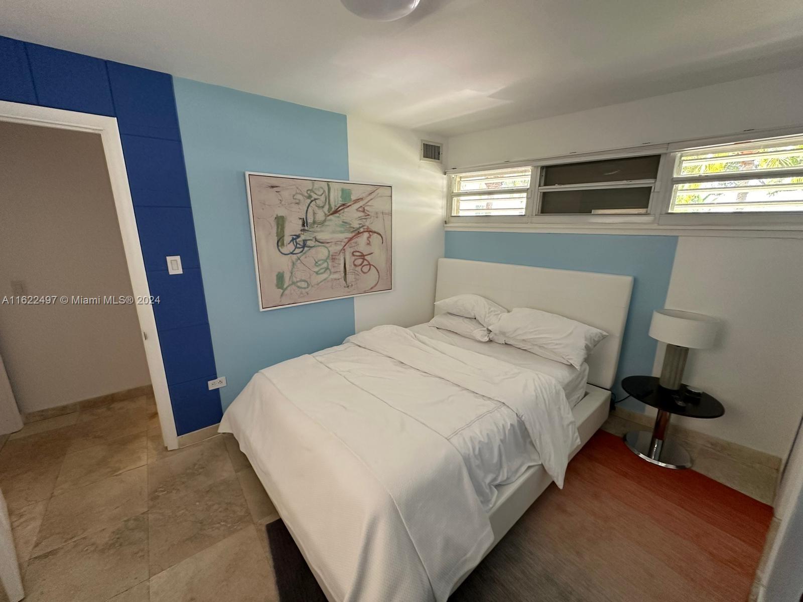 5301 Alton Road Miami Beach, FL 33140 - Photo 39 of 46 a bedroom with a bed and a window