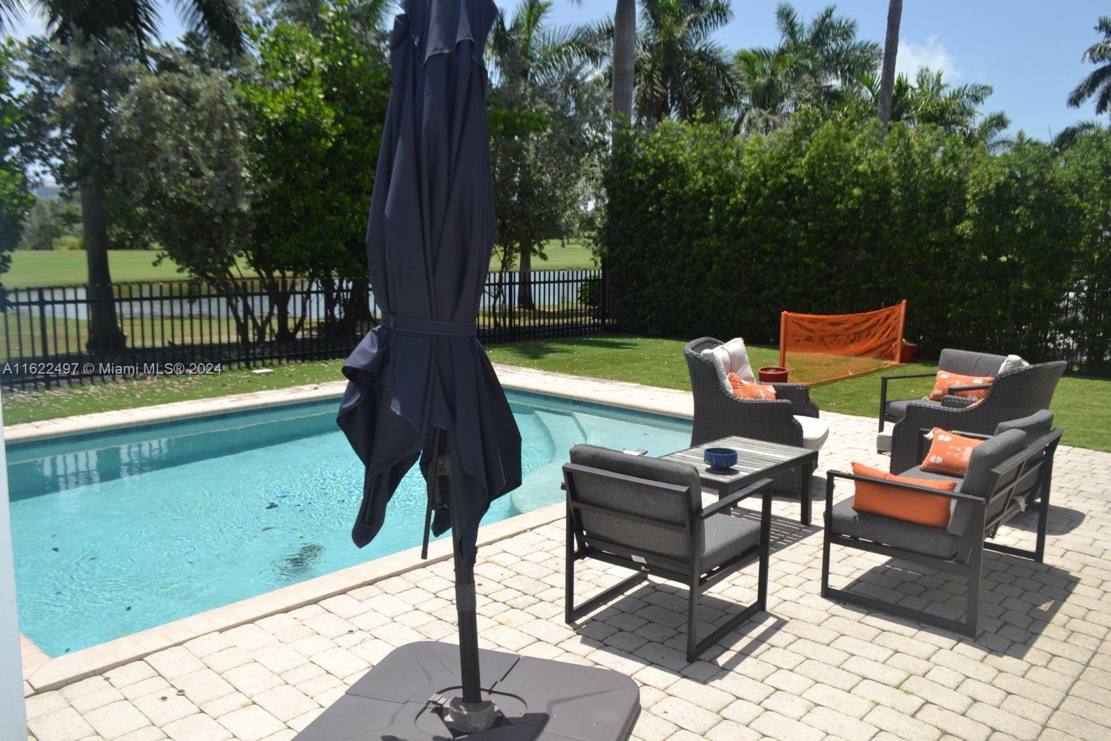 5301 Alton Road Miami Beach, FL 33140 - Photo 45 of 46 a backyard of a house with table and chairs