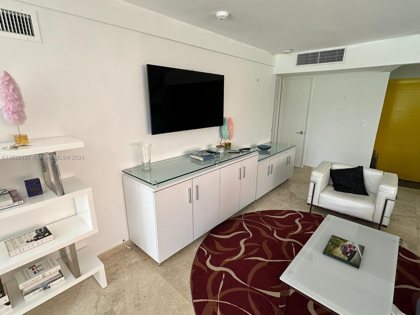 5301 Alton Road Miami Beach, FL 33140 - Photo 10 of 46 a living room with furniture and a flat screen tv