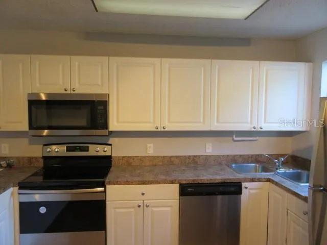 a kitchen with a stove and a microwave