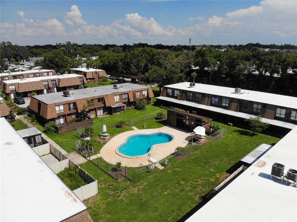 an aerial view of a house with a garden and lake view