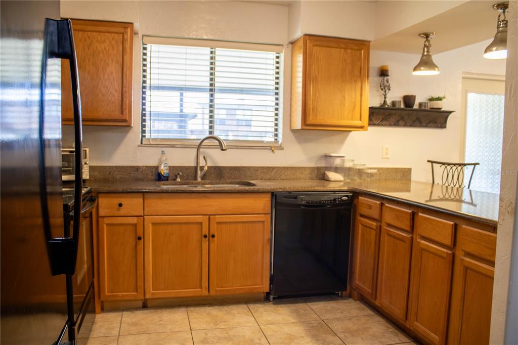 1836 North Crystal Lake Drive, Unit 95 Lakeland, FL 33801 - Photo 11 of 31 a kitchen with stainless steel appliances granite countertop a sink stove and refrigerator