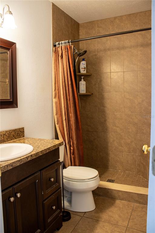 1836 North Crystal Lake Drive, Unit 95 Lakeland, FL 33801 - Photo 20 of 31 a bathroom with a granite countertop sink toilet and shower
