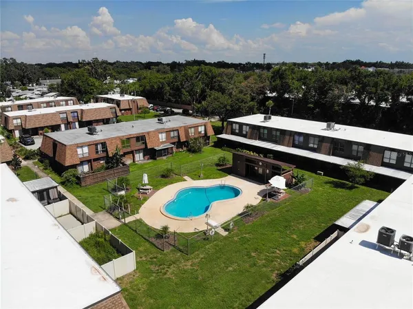 a view of a swimming pool and outdoor seating
