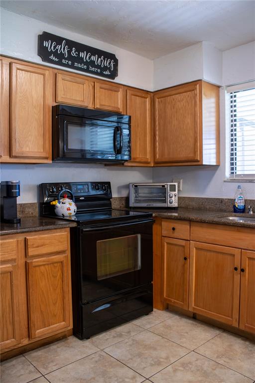1836 North Crystal Lake Drive, Unit 95 Lakeland, FL 33801 - Photo 10 of 31 a kitchen with stainless steel appliances granite countertop a stove a sink and a microwave