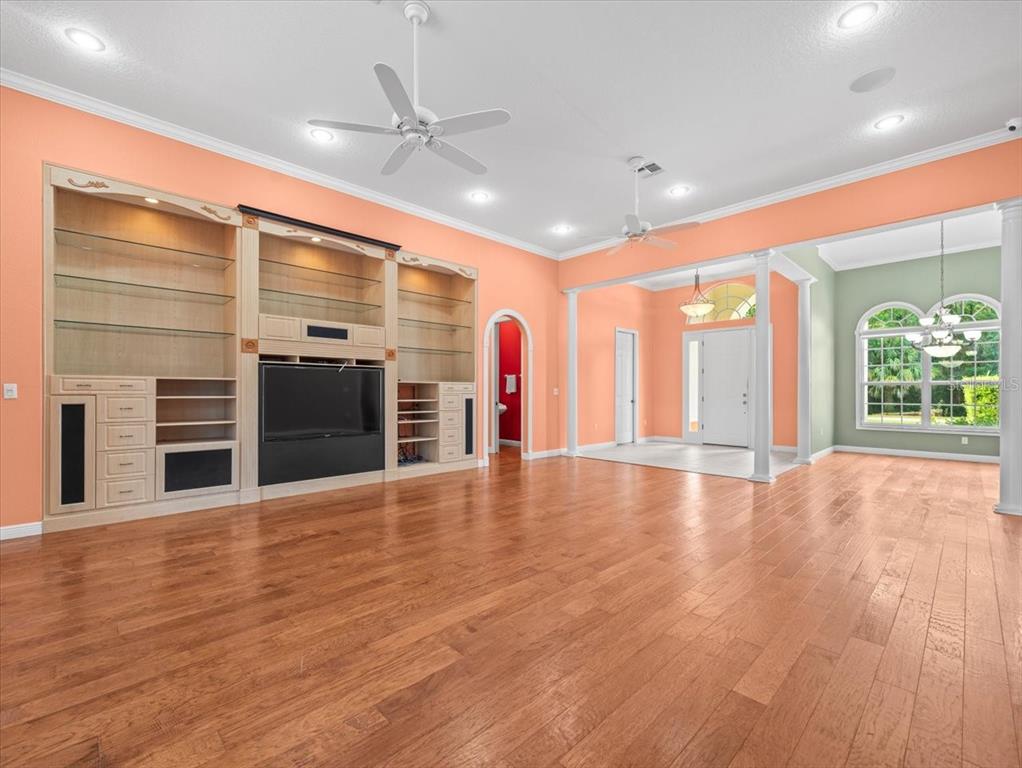 8698 Mississippi Run Weeki Wachee, FL 34613 - Photo 13 of 58 an empty room with wooden floor and windows