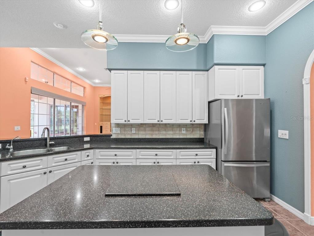 8698 Mississippi Run Weeki Wachee, FL 34613 - Photo 22 of 58 a kitchen with stainless steel appliances granite countertop a sink a stove and a refrigerator