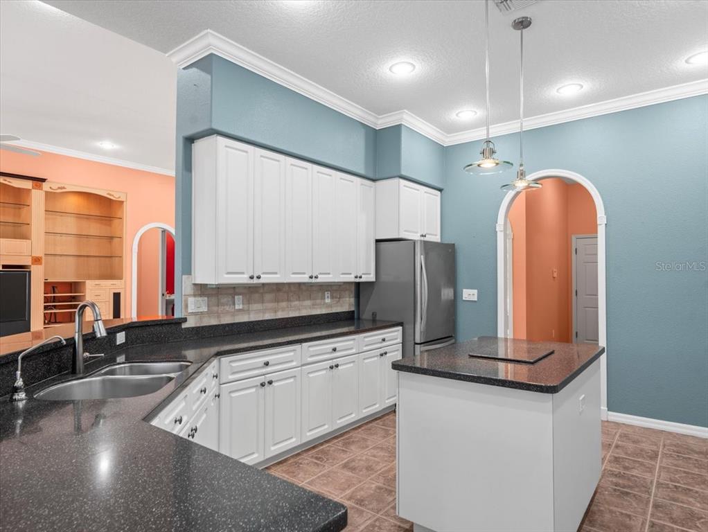 8698 Mississippi Run Weeki Wachee, FL 34613 - Photo 24 of 58 a kitchen with stainless steel appliances granite countertop a sink a stove and a refrigerator