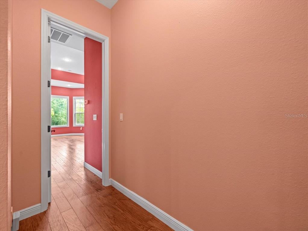 8698 Mississippi Run Weeki Wachee, FL 34613 - Photo 29 of 58 a view of a hallway with wooden floor and a window