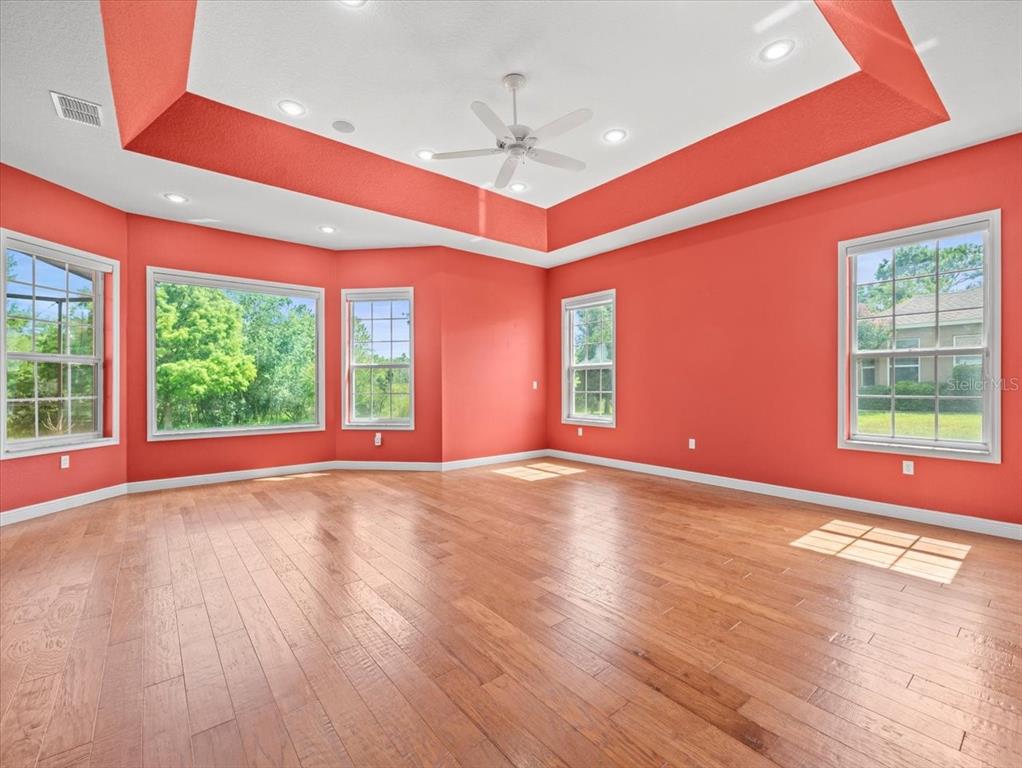 8698 Mississippi Run Weeki Wachee, FL 34613 - Photo 31 of 58 a view of empty room with wooden floor and fan