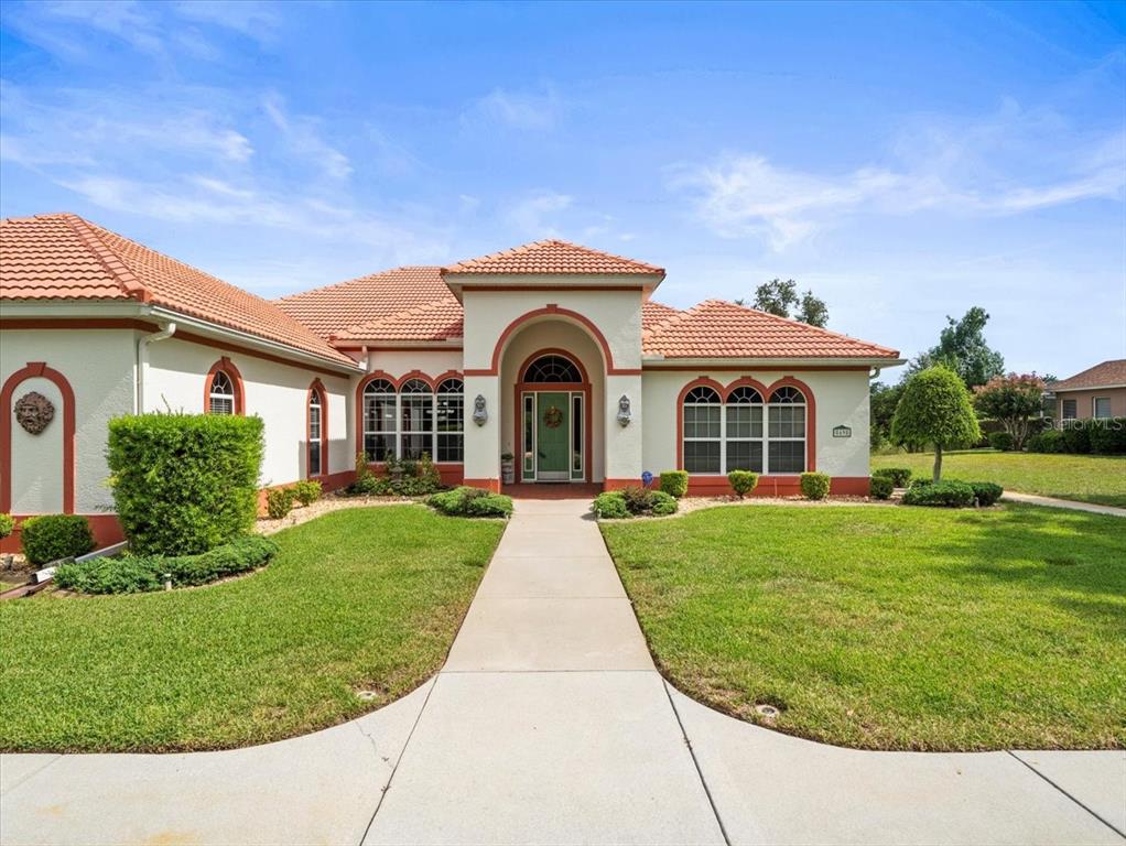 8698 Mississippi Run Weeki Wachee, FL 34613 - Photo 6 of 58 front view of a house with a yard