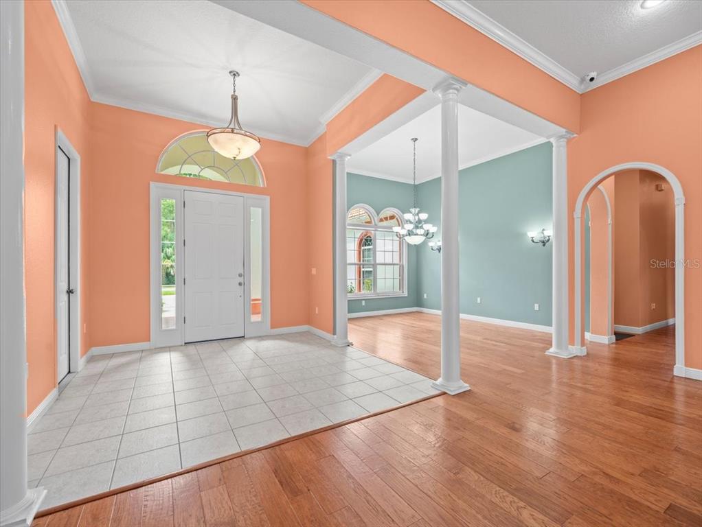8698 Mississippi Run Weeki Wachee, FL 34613 - Photo 7 of 58 a view of an empty room with wooden floor and a window