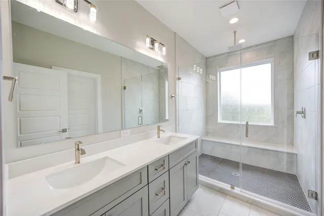 a bathroom with 2 sink tub and a mirror