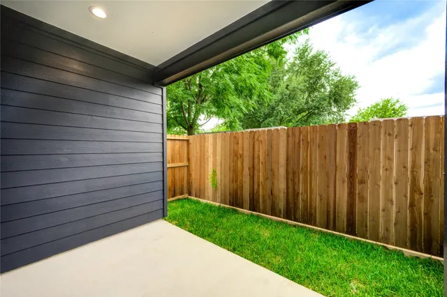 a view of a backyard with wooden fence
