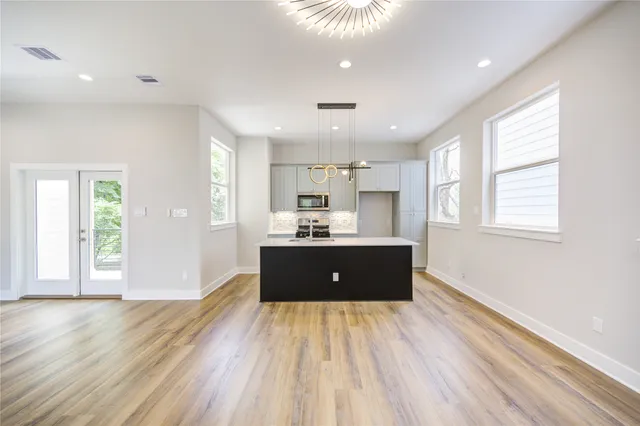 a view of a kitchen center island wooden floor and windows