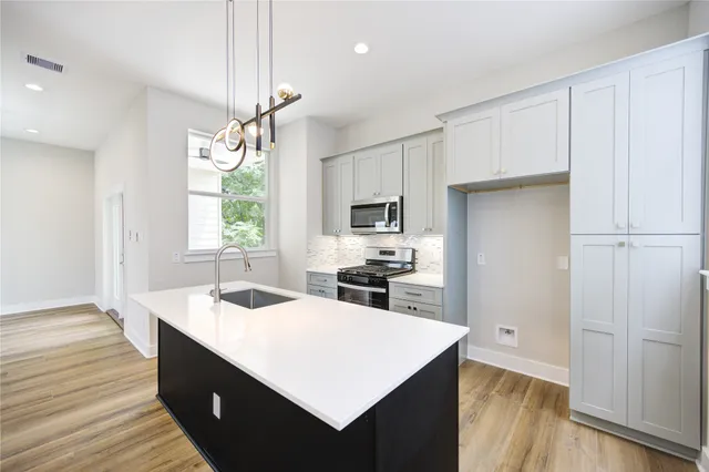 a kitchen with a sink stove and refrigerator