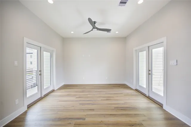 wooden floor in an empty room with a window