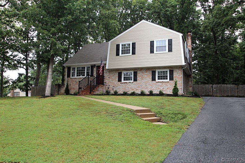 12010 West Petty Road Midlothian, VA 23113 - Photo 1 of 20 a front view of a house with a garden and yard