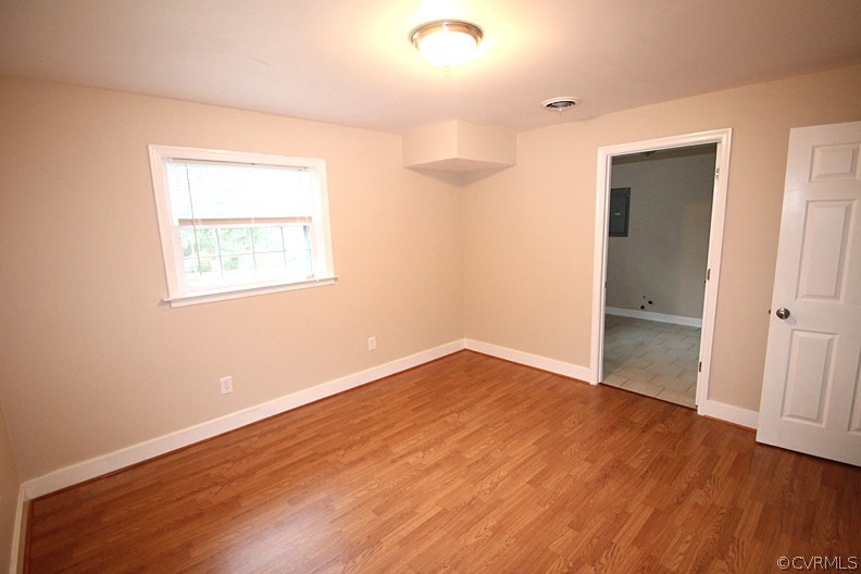 12010 West Petty Road Midlothian, VA 23113 - Photo 11 of 20 an empty room with wooden floor and windows