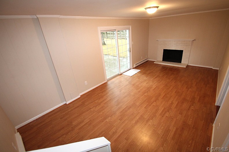 12010 West Petty Road Midlothian, VA 23113 - Photo 6 of 20 a view of an empty room with wooden floor and a window