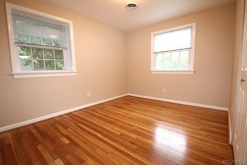12010 West Petty Road Midlothian, VA 23113 - Photo 7 of 20 an empty room with wooden floor and windows