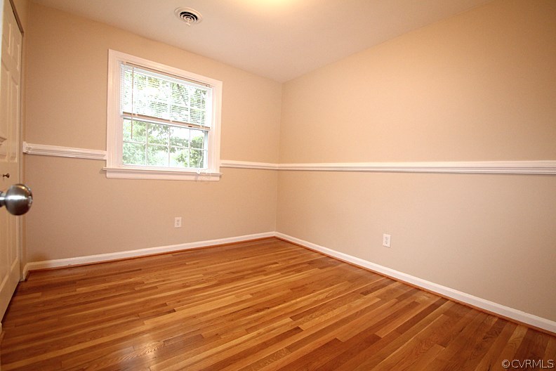 12010 West Petty Road Midlothian, VA 23113 - Photo 9 of 20 an empty room with wooden floor and windows