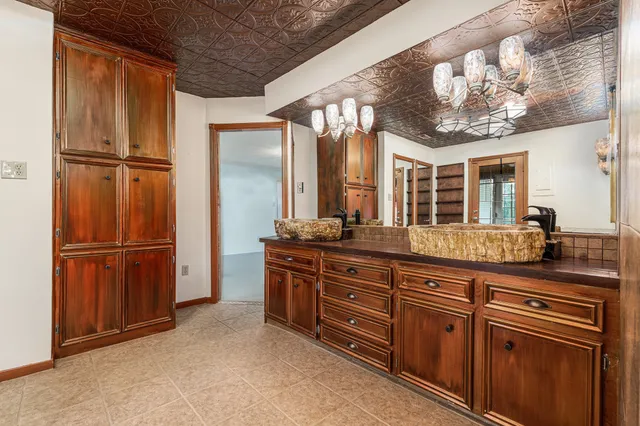 a spacious bathroom with a granite countertop sink a mirror and a vanity