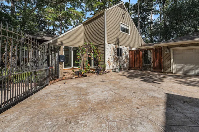 a view of a house with backyard and sitting area