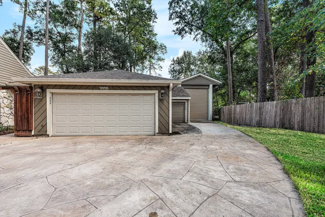 a view of house with backyard and trees