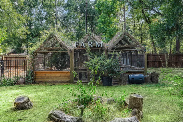 a front view of a house with a garden and plants