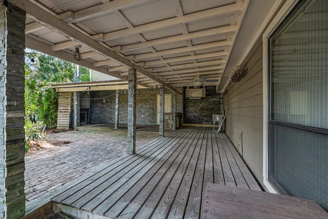 a view of backyard with a deck and wooden floor