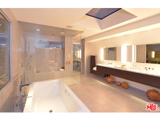 1645 Carla Ridge Beverly Hills, CA 90210 - Photo 17 of 26 a bathroom with a tub sink and mirror