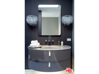 1645 Carla Ridge Beverly Hills, CA 90210 - Photo 20 of 26 a bathroom with a sink and a mirror