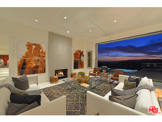 1645 Carla Ridge Beverly Hills, CA 90210 - Photo 4 of 26 a living room with furniture a fireplace and a flat screen tv