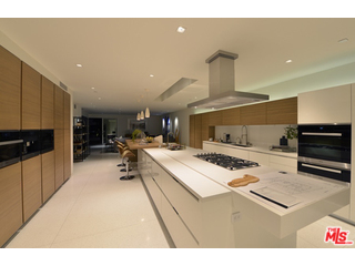 1645 Carla Ridge Beverly Hills, CA 90210 - Photo 5 of 26 a living room with stainless steel appliances kitchen island a table and chairs