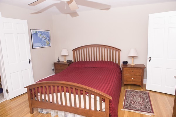 18 Jenness Street Quincy, MA 02169 - Photo 16 of 29 a bedroom with a bed and wooden floor