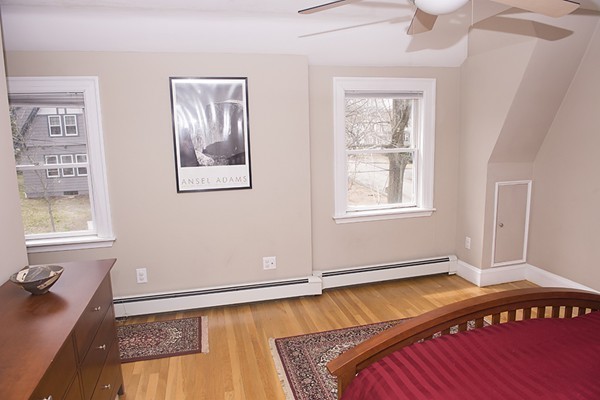 18 Jenness Street Quincy, MA 02169 - Photo 17 of 29 a bedroom with a bed and wooden floor