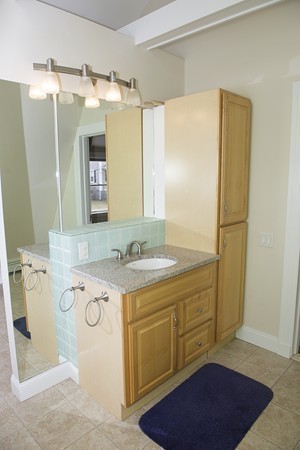 18 Jenness Street Quincy, MA 02169 - Photo 21 of 29 a bathroom with a granite countertop sink and a mirror