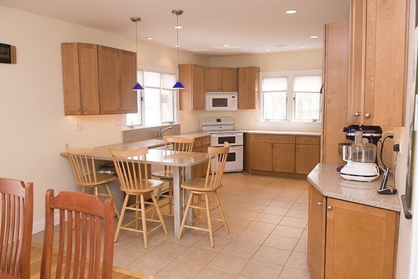 18 Jenness Street Quincy, MA 02169 - Photo 5 of 29 a kitchen with stainless steel appliances kitchen island granite countertop a sink and cabinets