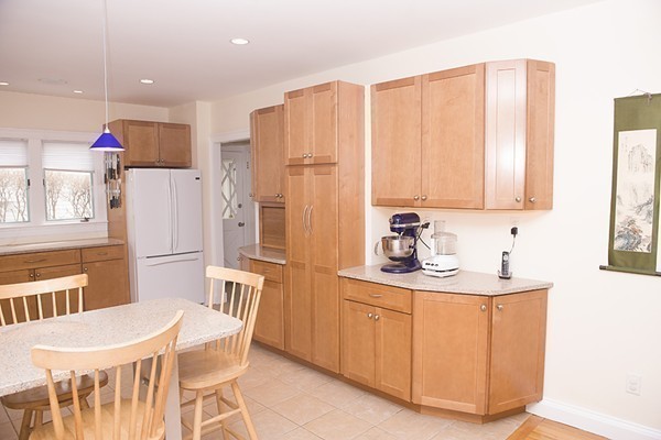 18 Jenness Street Quincy, MA 02169 - Photo 7 of 29 a kitchen with stainless steel appliances a sink a stove a refrigerator a dining table and chairs